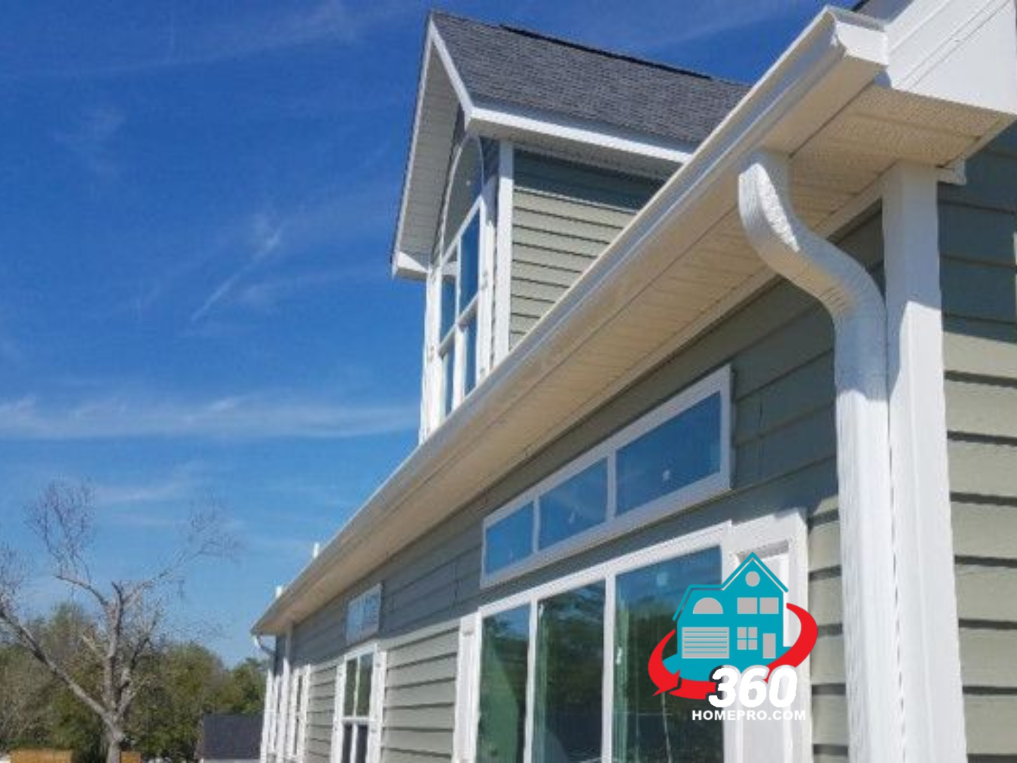 A house with a lot of windows and a gutter on the side of it.