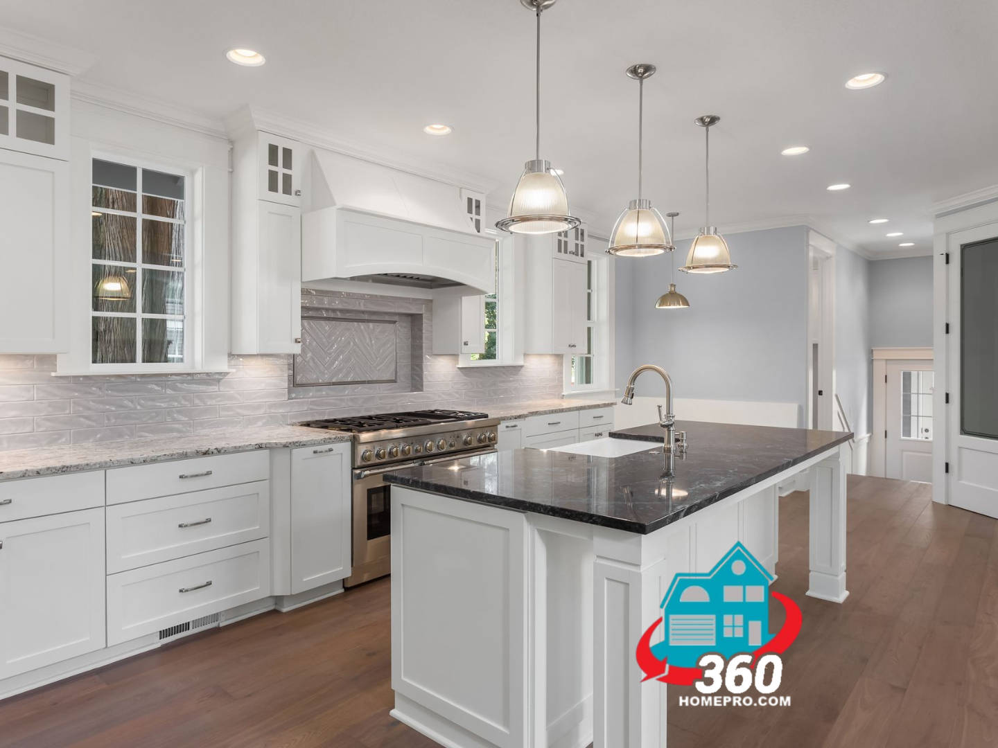 A kitchen with white cabinets , granite counter tops , stainless steel appliances and a large island.