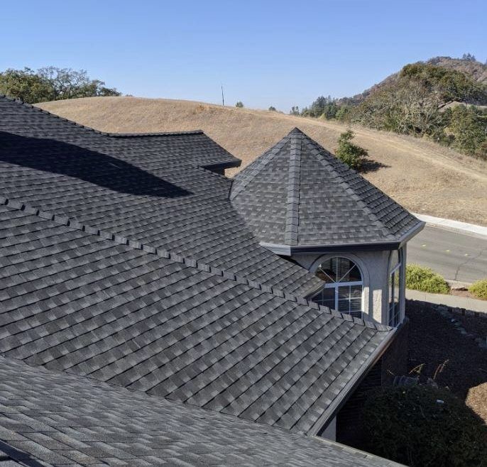 An aerial view of a house with a black roof