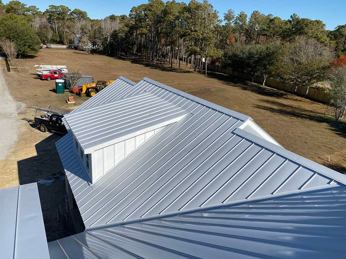 An aerial view of a house with a metal roof.