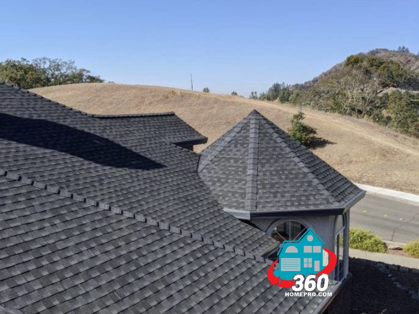 An aerial view of a house with a black roof