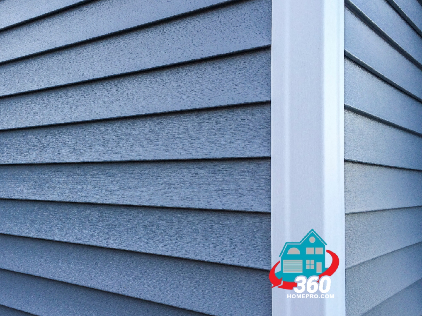 A close up of a blue siding on a house with a white trim.