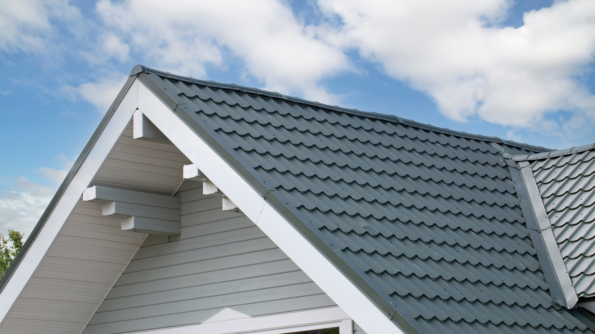 The roof of a house with a blue sky in the background