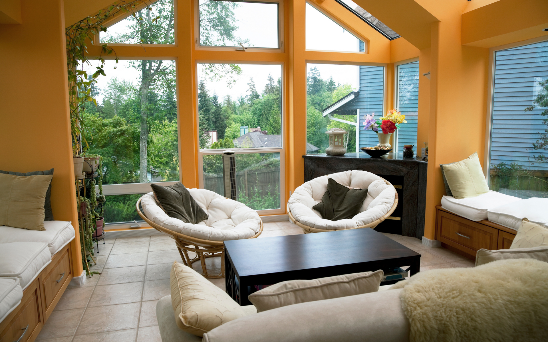 A living room with a lot of windows and chairs