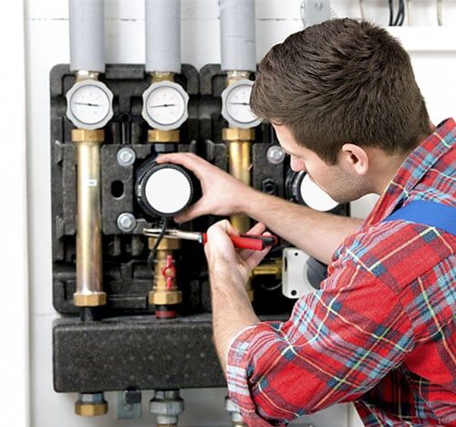 Technician servicing heating boiler in Brookville, OH Technician servicing heating boiler in Brookville, OH