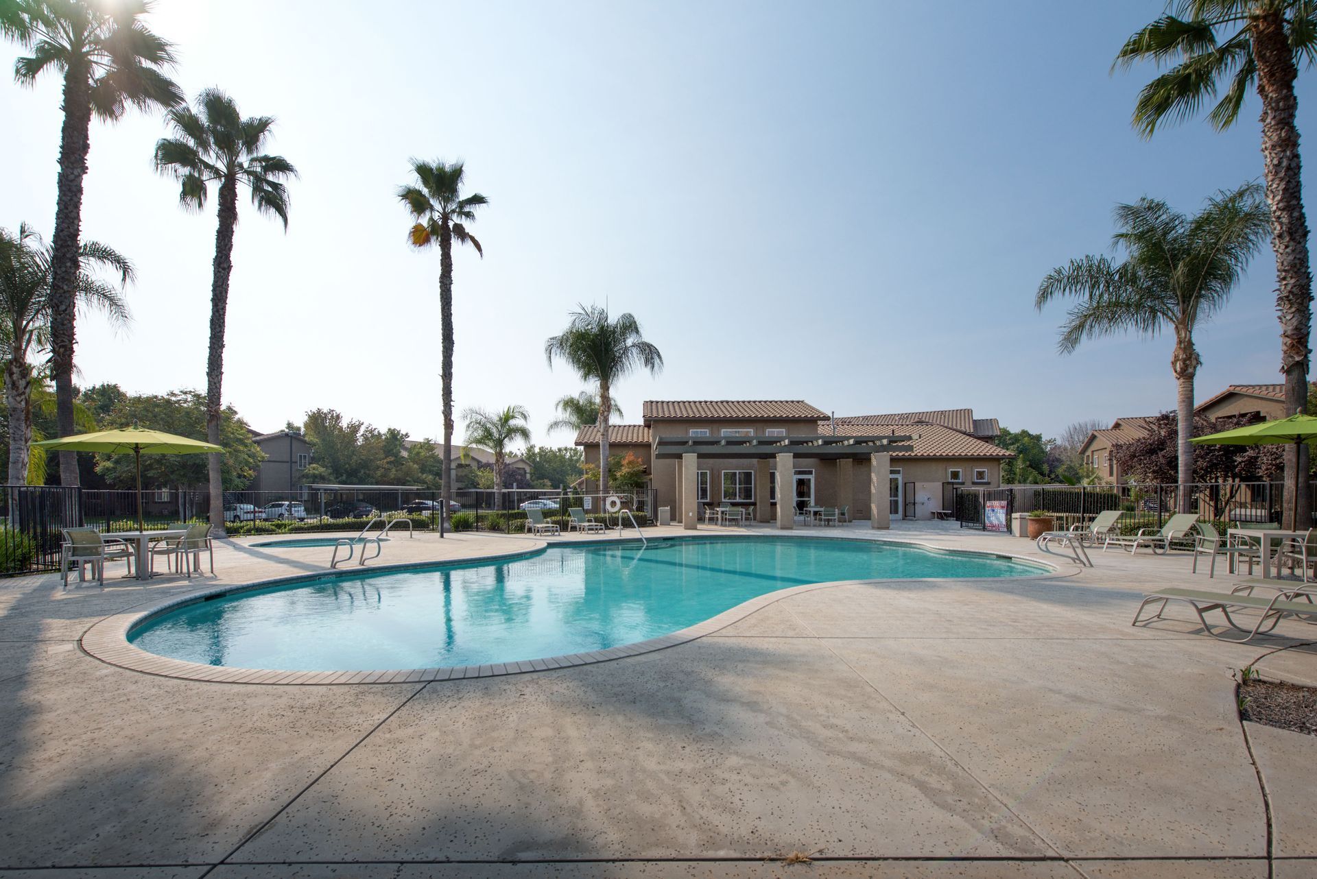 a large swimming pool surrounded by umbrellas and chairs
