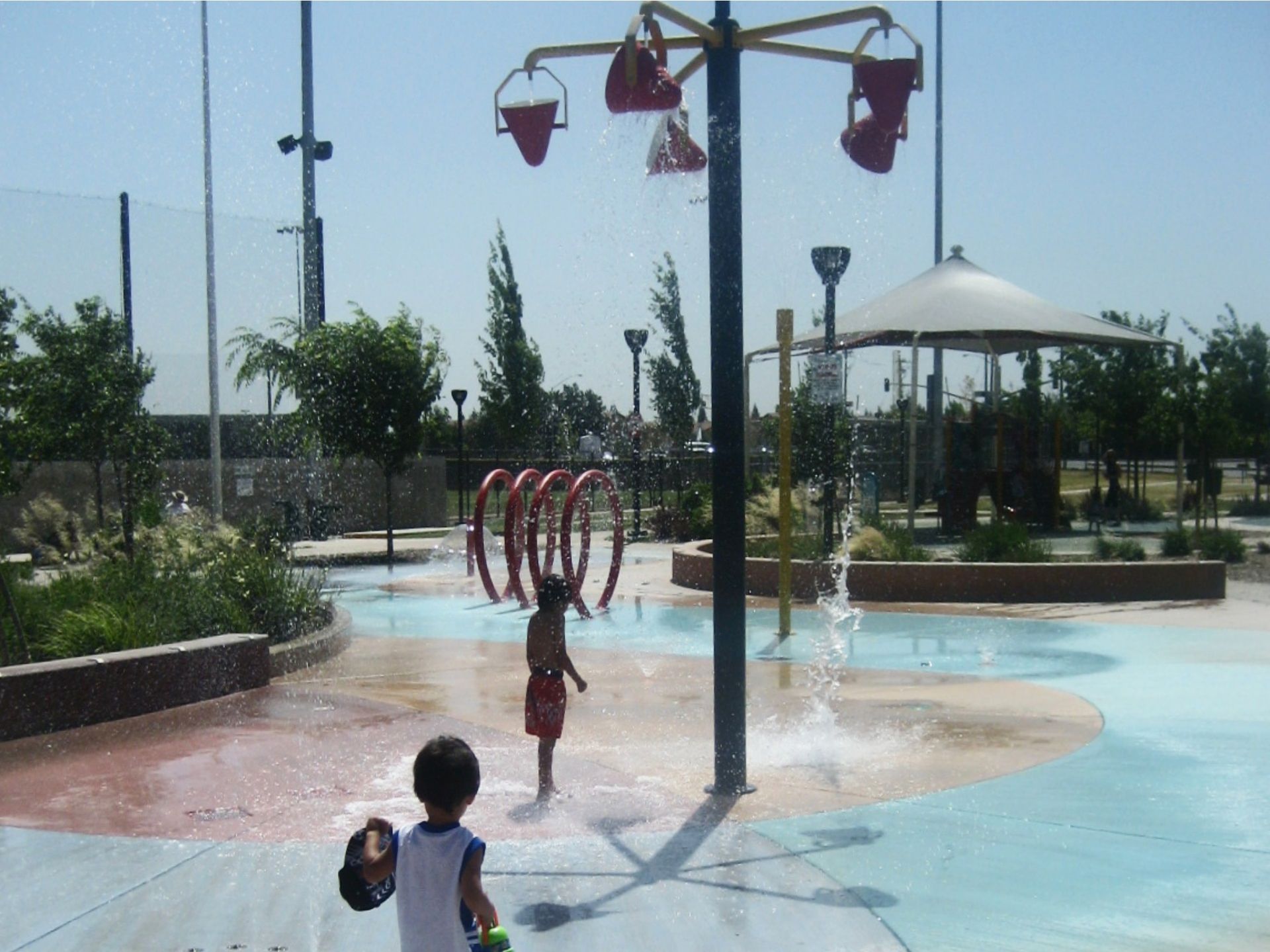 a young boy is playing in a water park