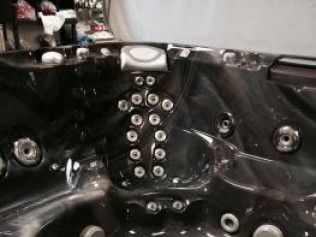 A close up of a hot tub with a lot of holes in it.
