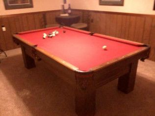 A pool table in a room with a red cloth