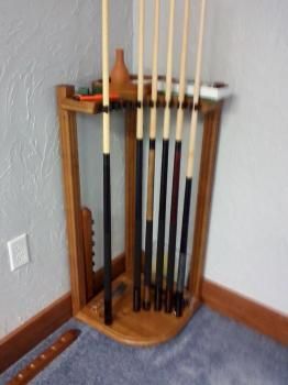 A pool cue rack in a corner of a room