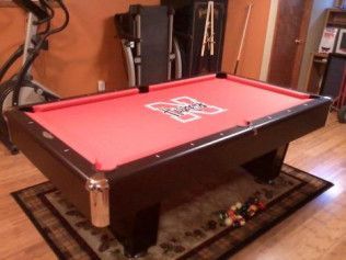 A pool table with a red cloth and the number 22 on it
