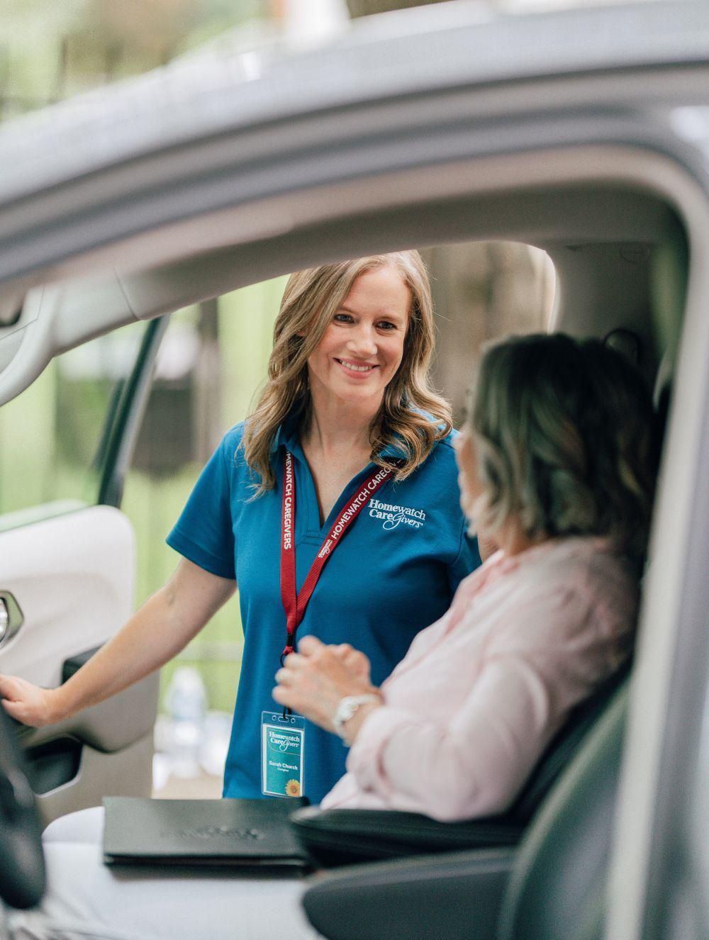 Caregiver smiling and engaging with a client at home