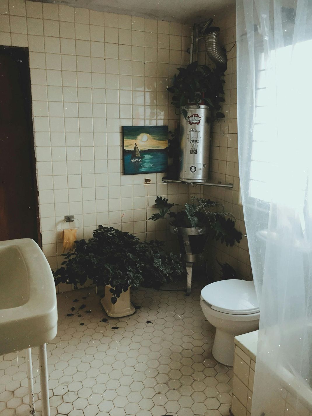 A bathroom with a sink , toilet , and shower curtain.
