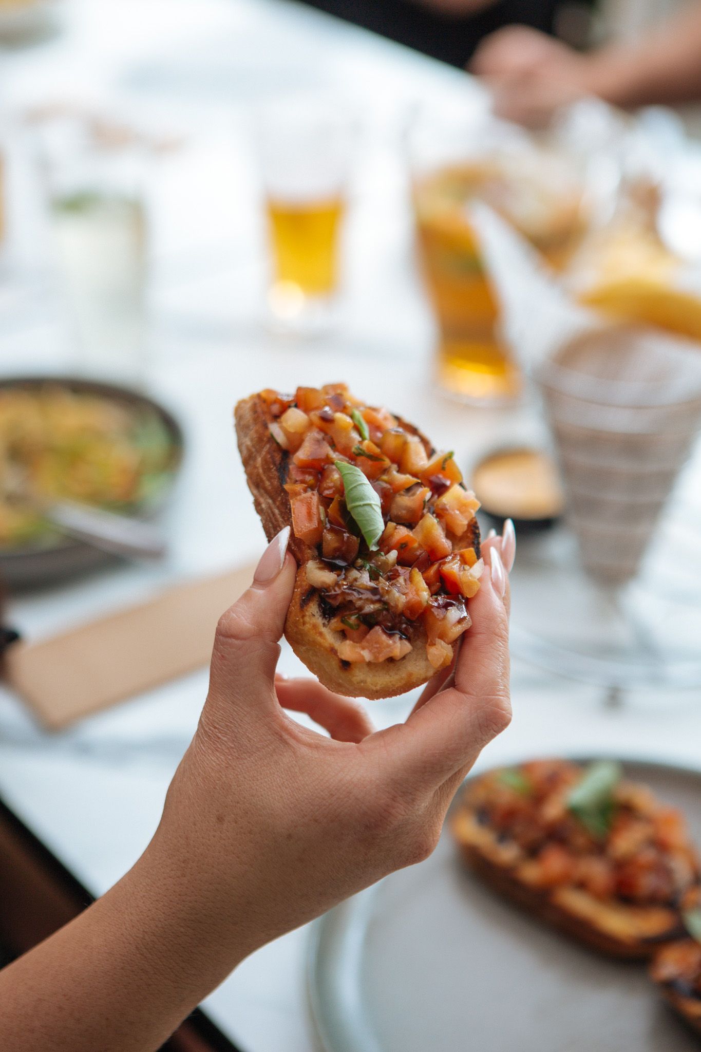 A plate of food with french fries and a glass of beer on a table at Para Hills Community Club