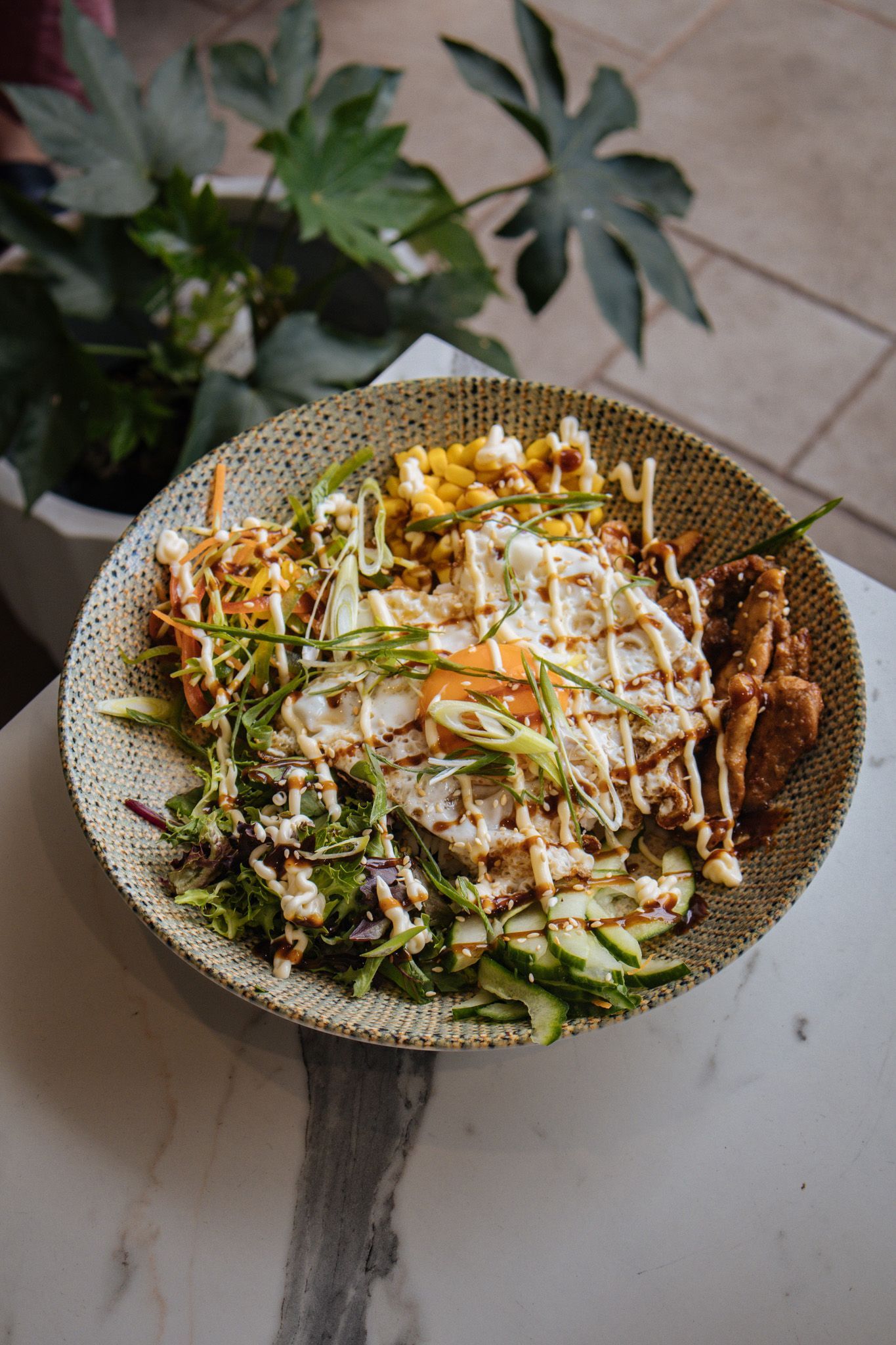 A plate of food with french fries and a glass of beer on a table at Para Hills Community Club