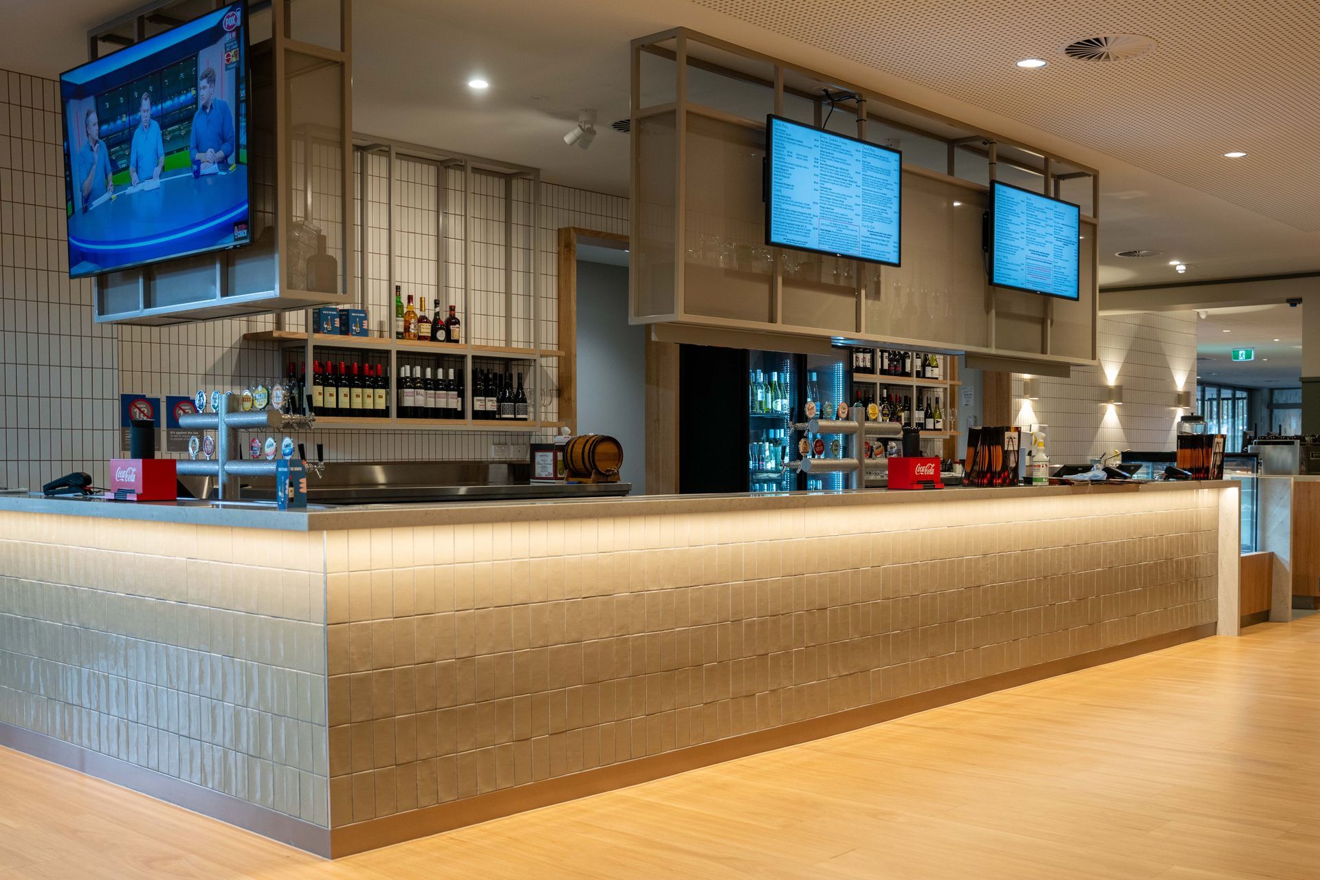 A group of children are sitting in front of a large screen watching a show at Para Hills Community Club