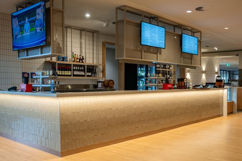 A group of children are sitting in front of a large screen watching a show at Para Hills Community Club
