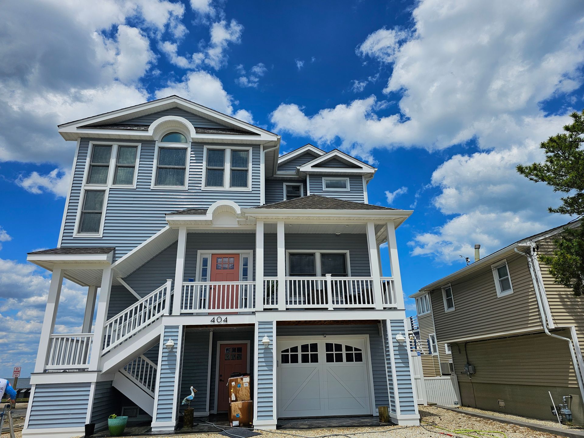 A large house with stairs leading up to the front door.