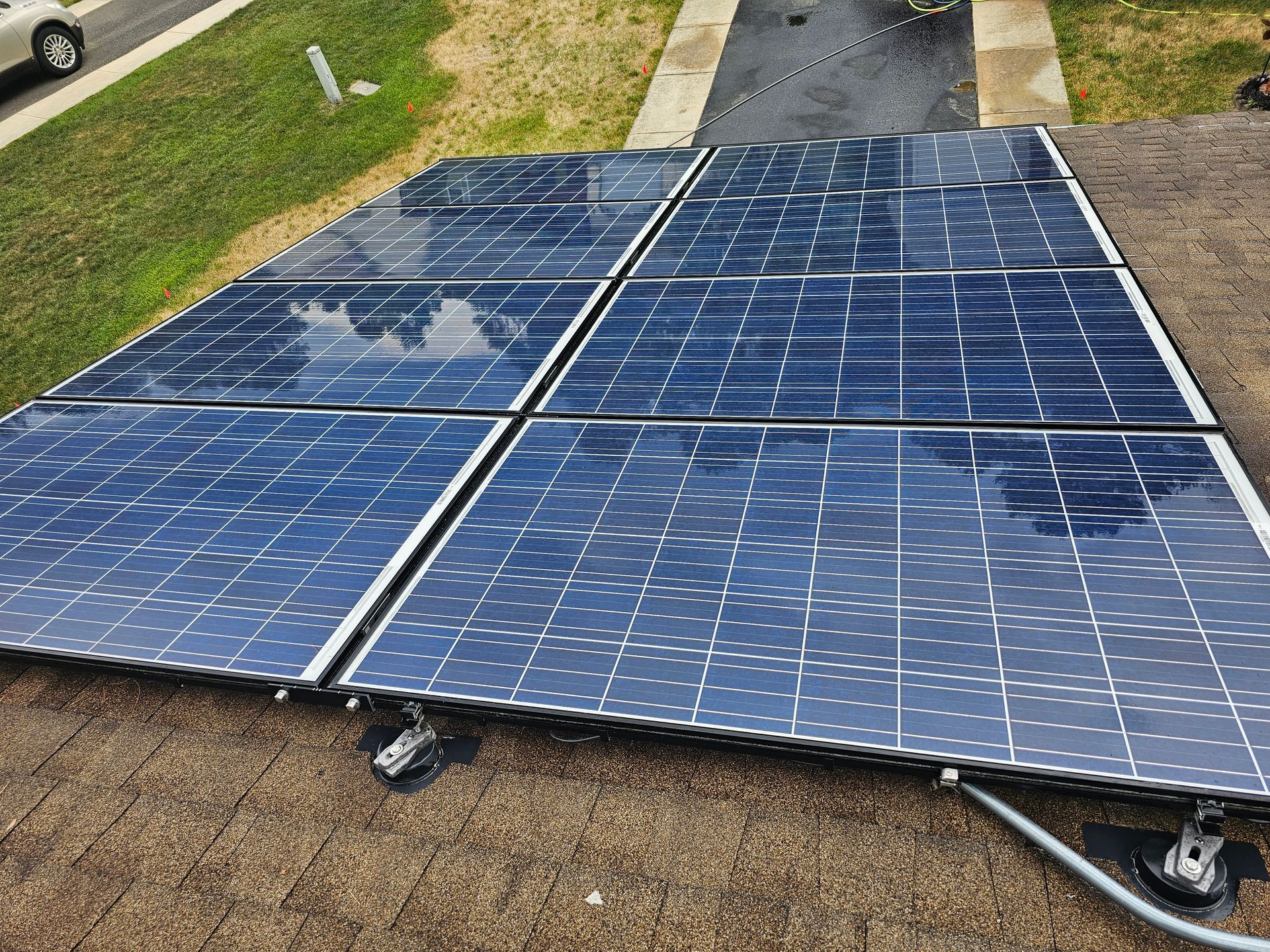 A row of solar panels sitting on top of a dirt field.