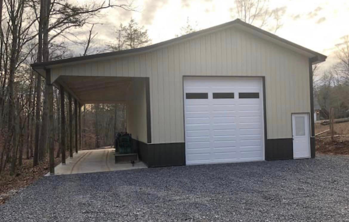 A garage with a porch and a white garage door.