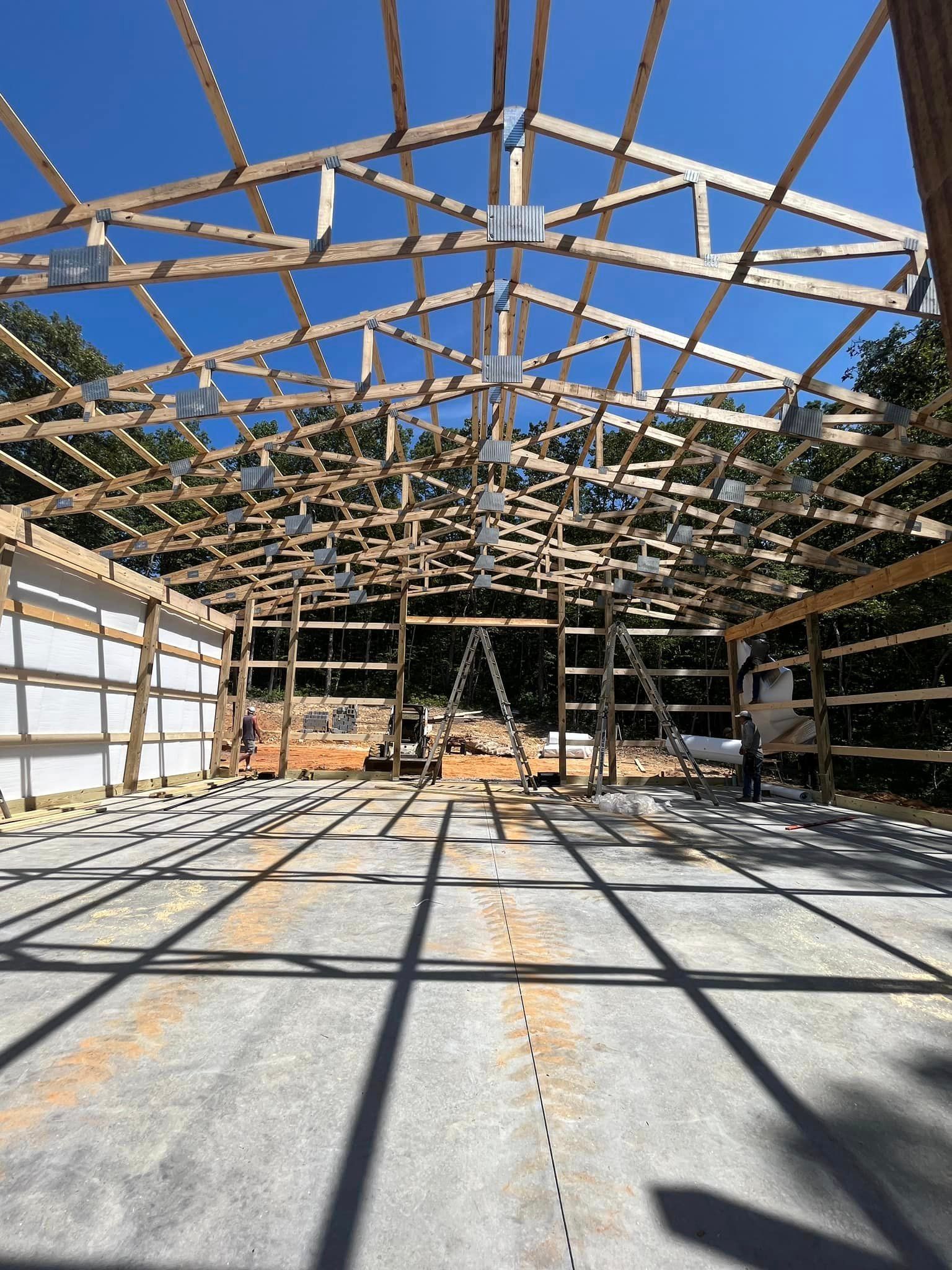 A large wooden structure is being built on a sunny day