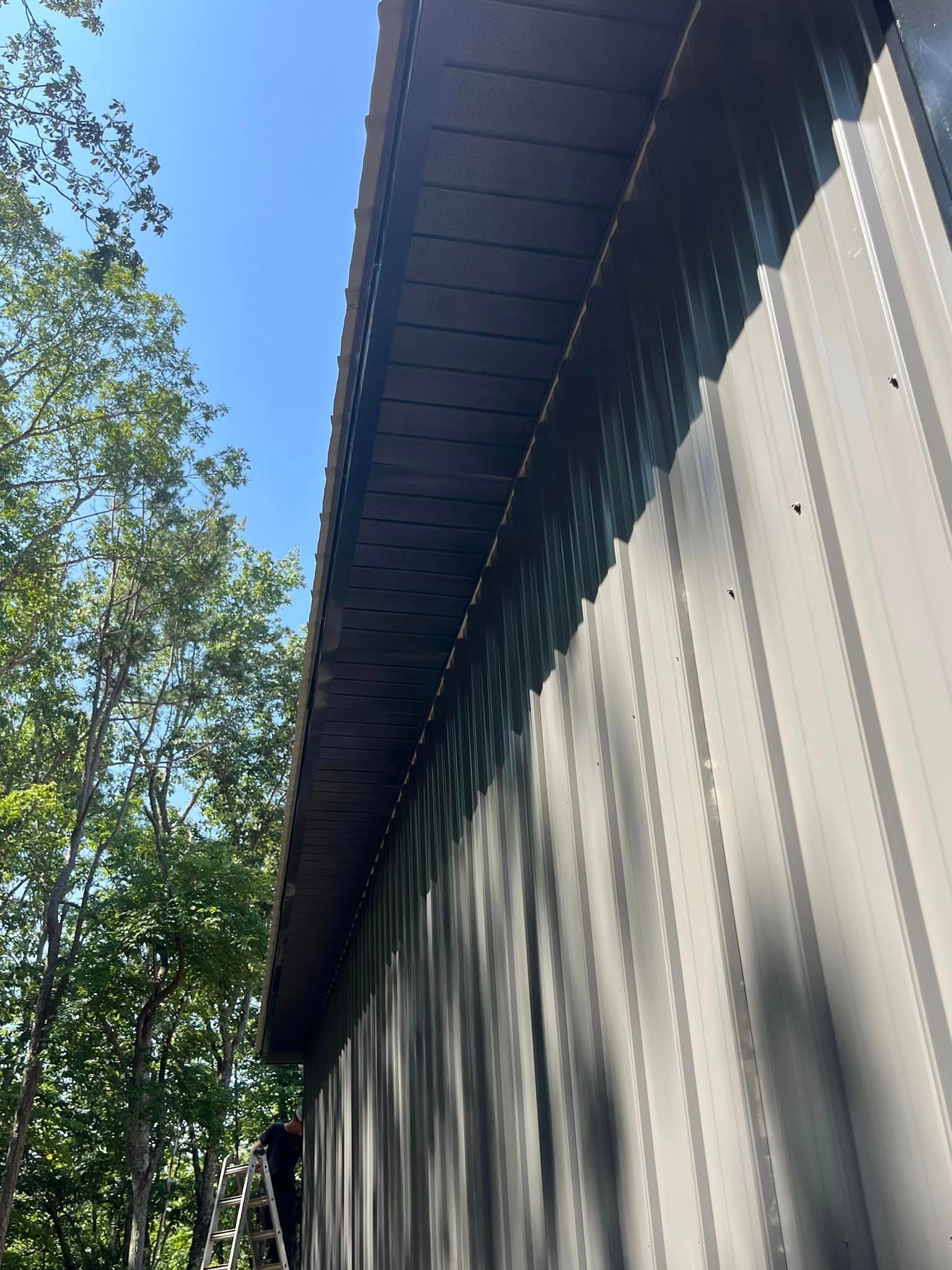 A close up of a roof of a building with trees in the background.