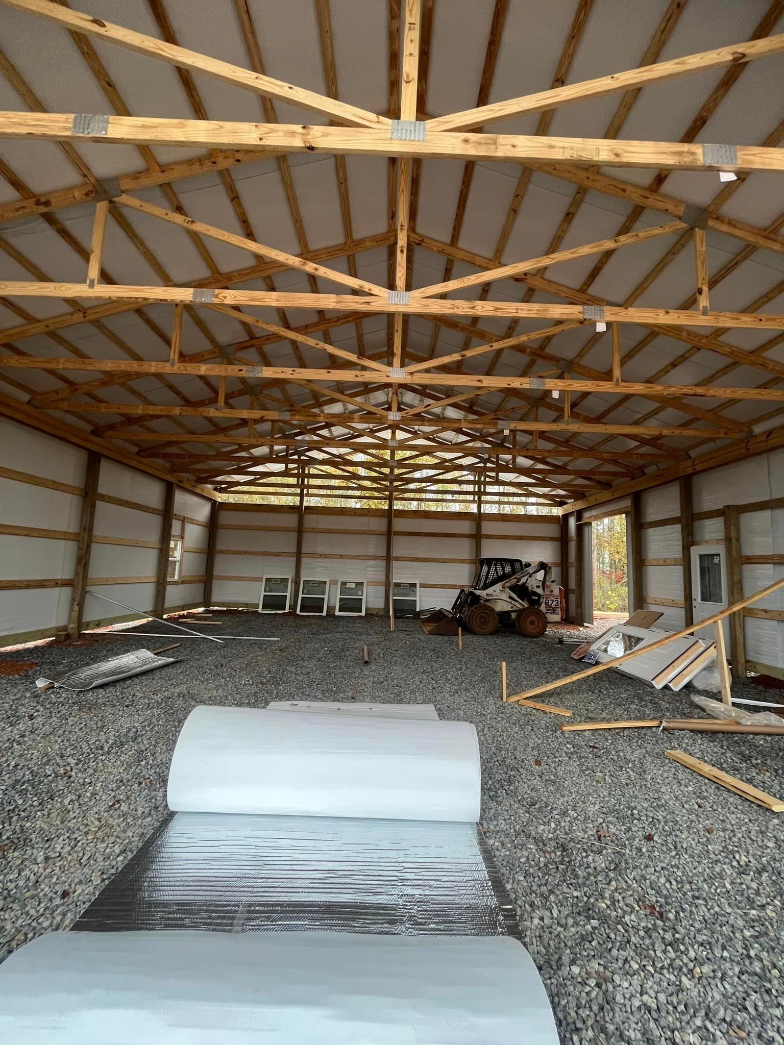 A large wooden building with a lot of rocks in the floor.