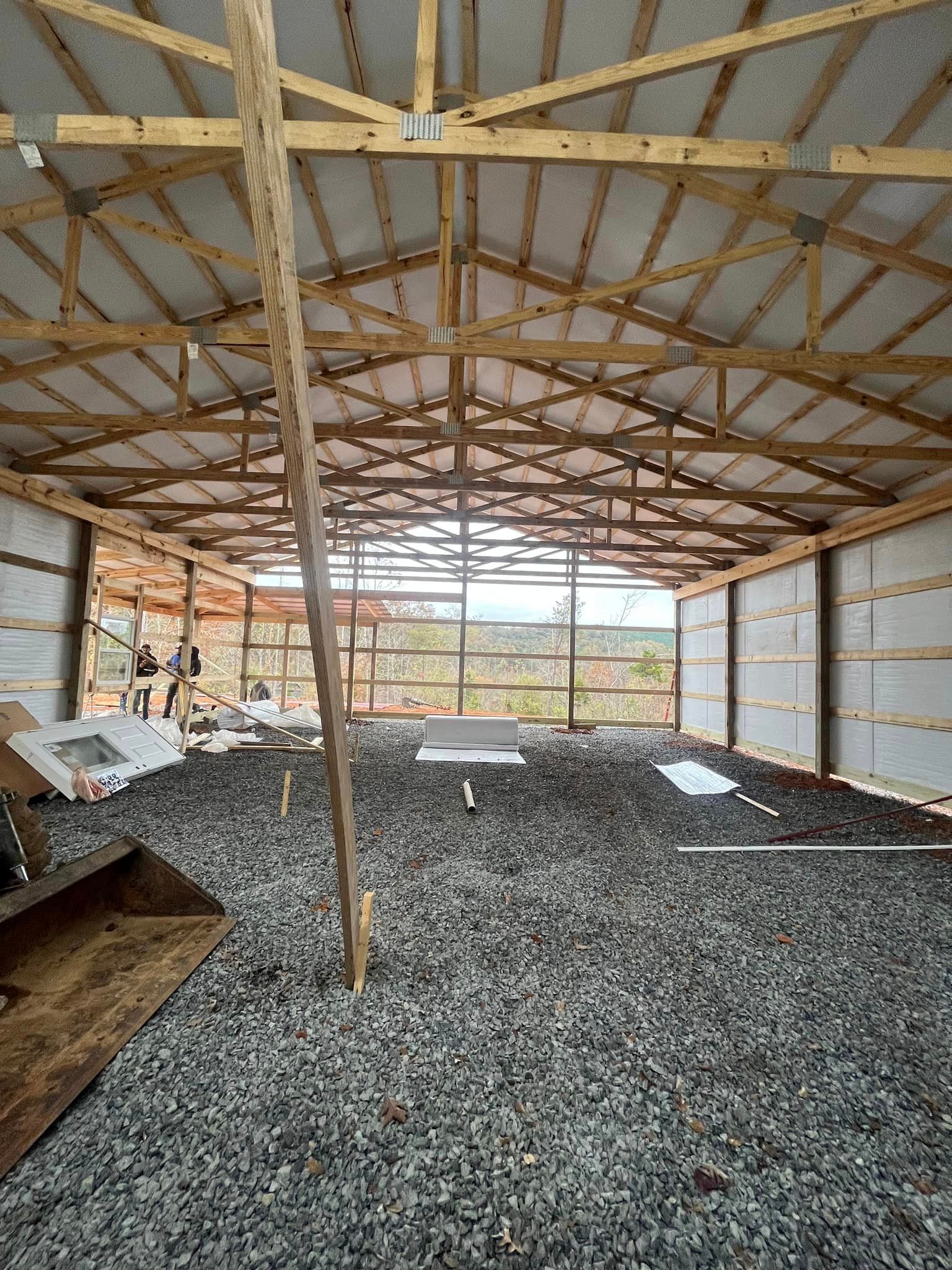 The inside of a building under construction with gravel in the floor.