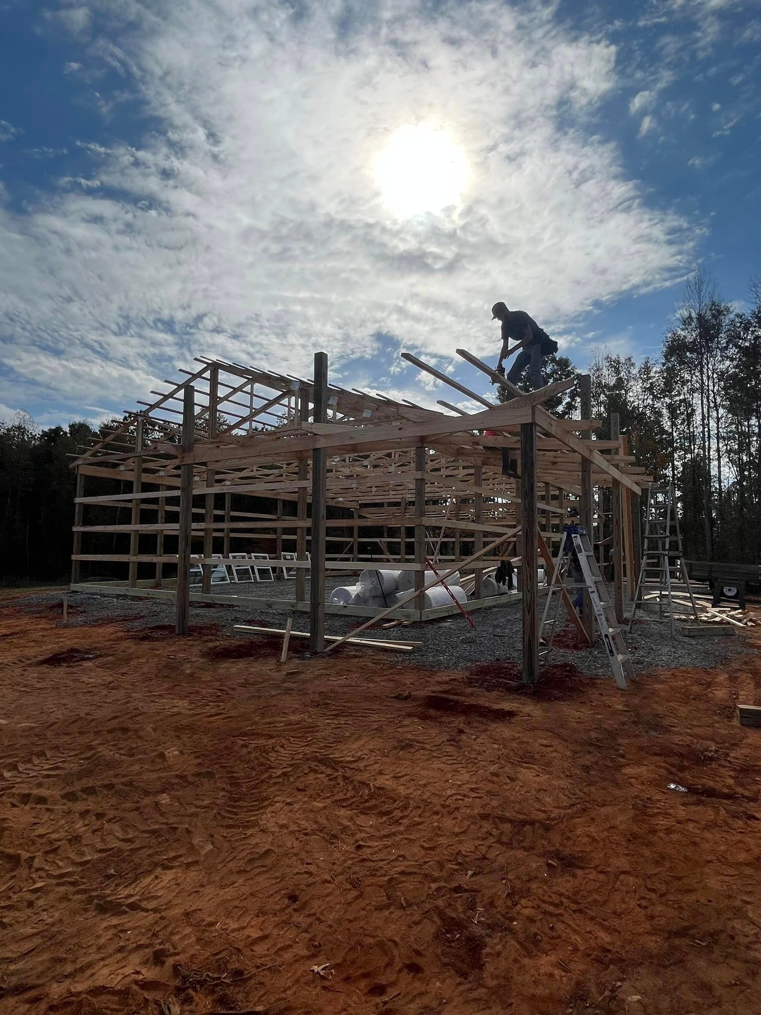 A man is standing on top of a wooden structure.