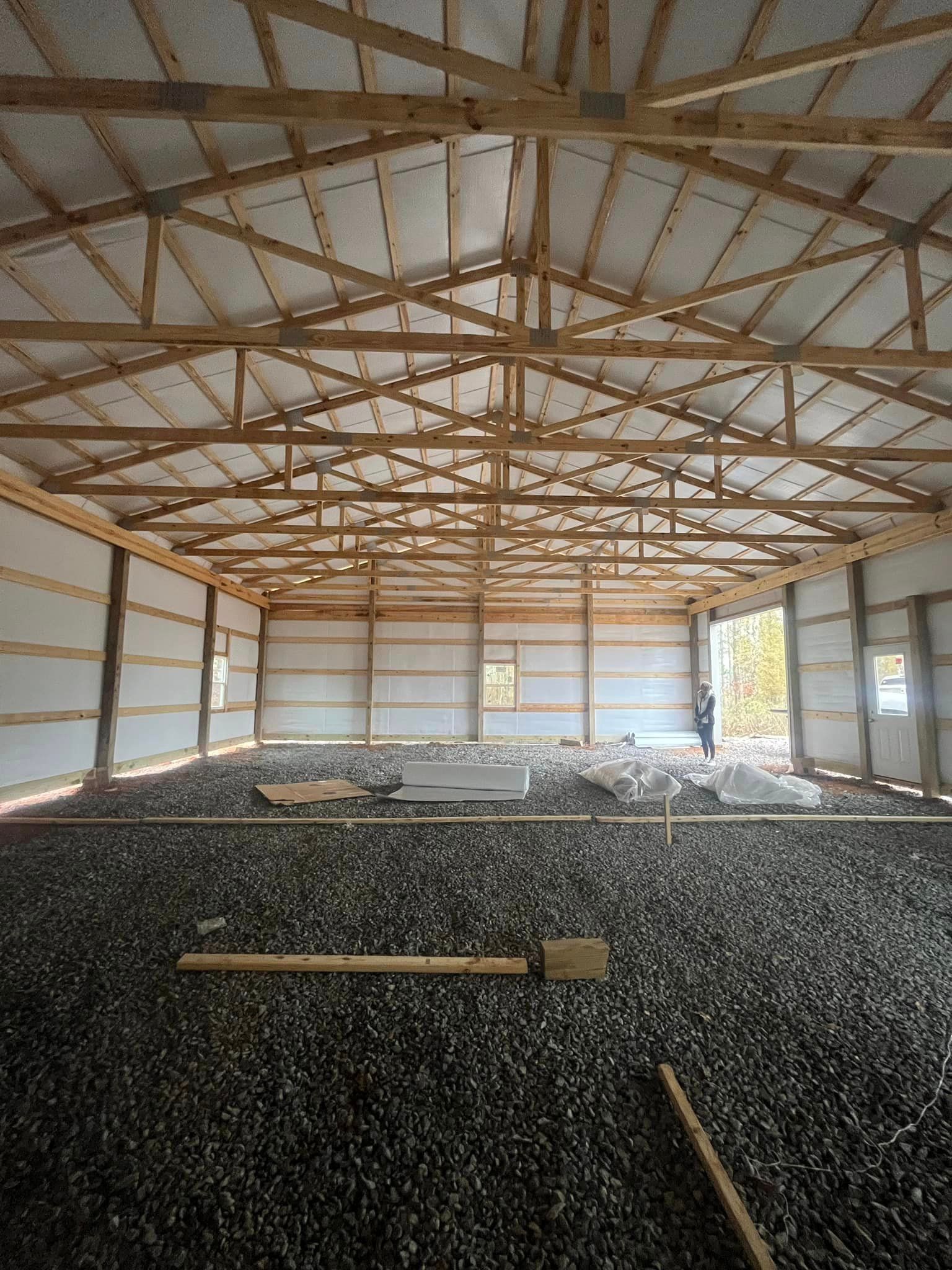 The inside of a building under construction with a lot of gravel on the floor.