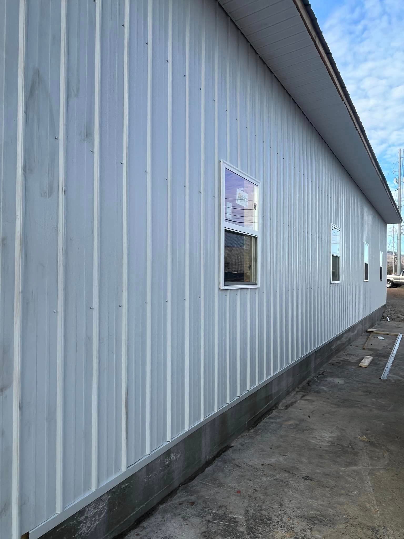 A white building with a lot of windows on the side of it.