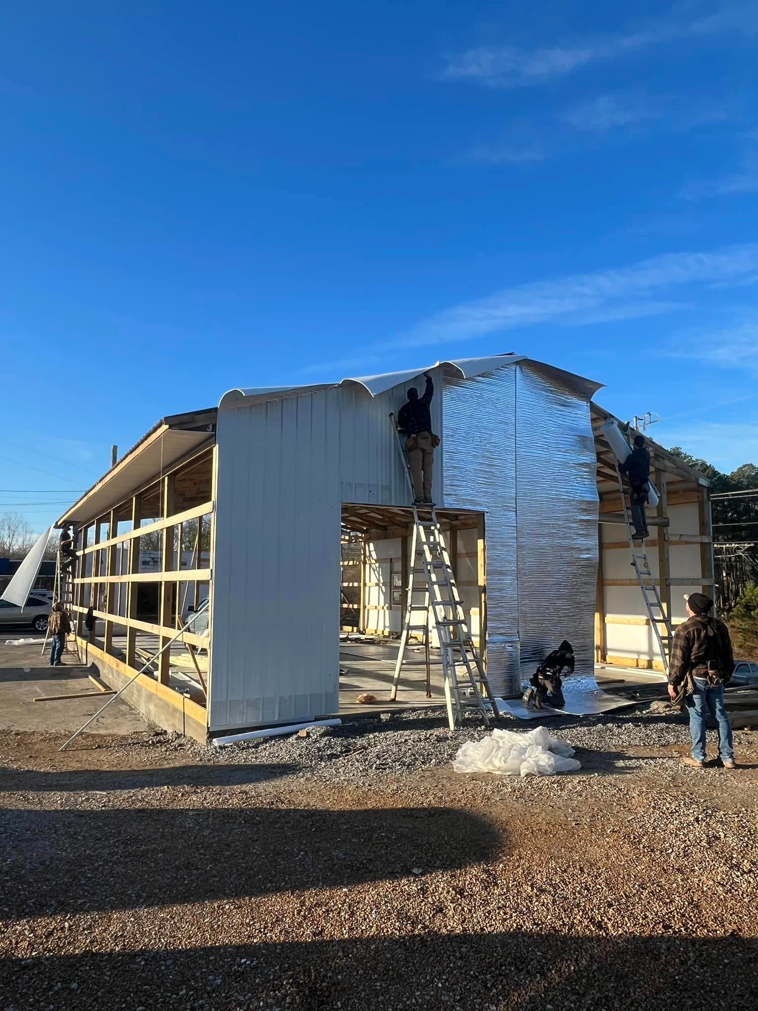 A group of people are working on a building under construction.