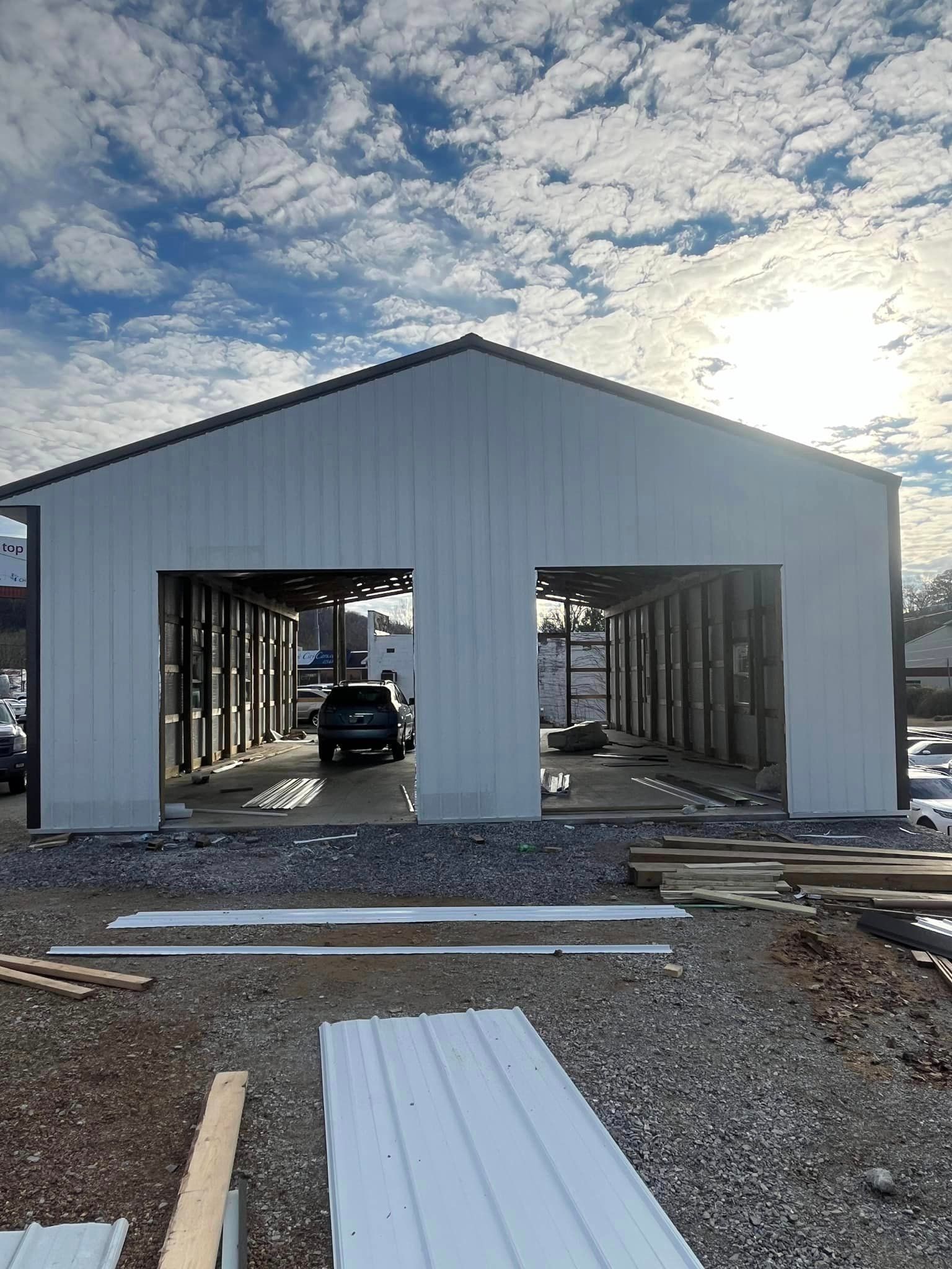 A white building with a car parked inside of it.