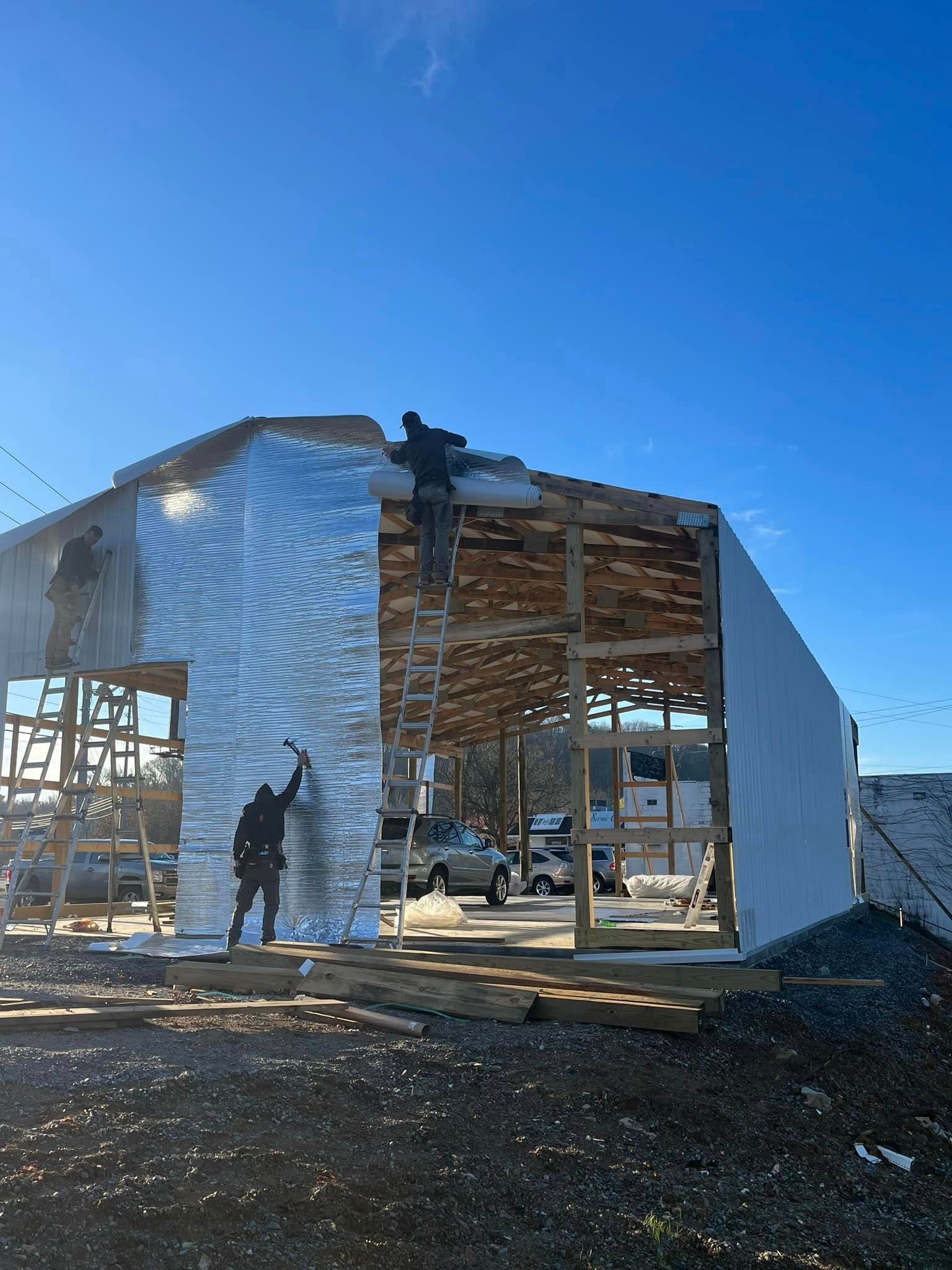 A man is standing on top of a building under construction.