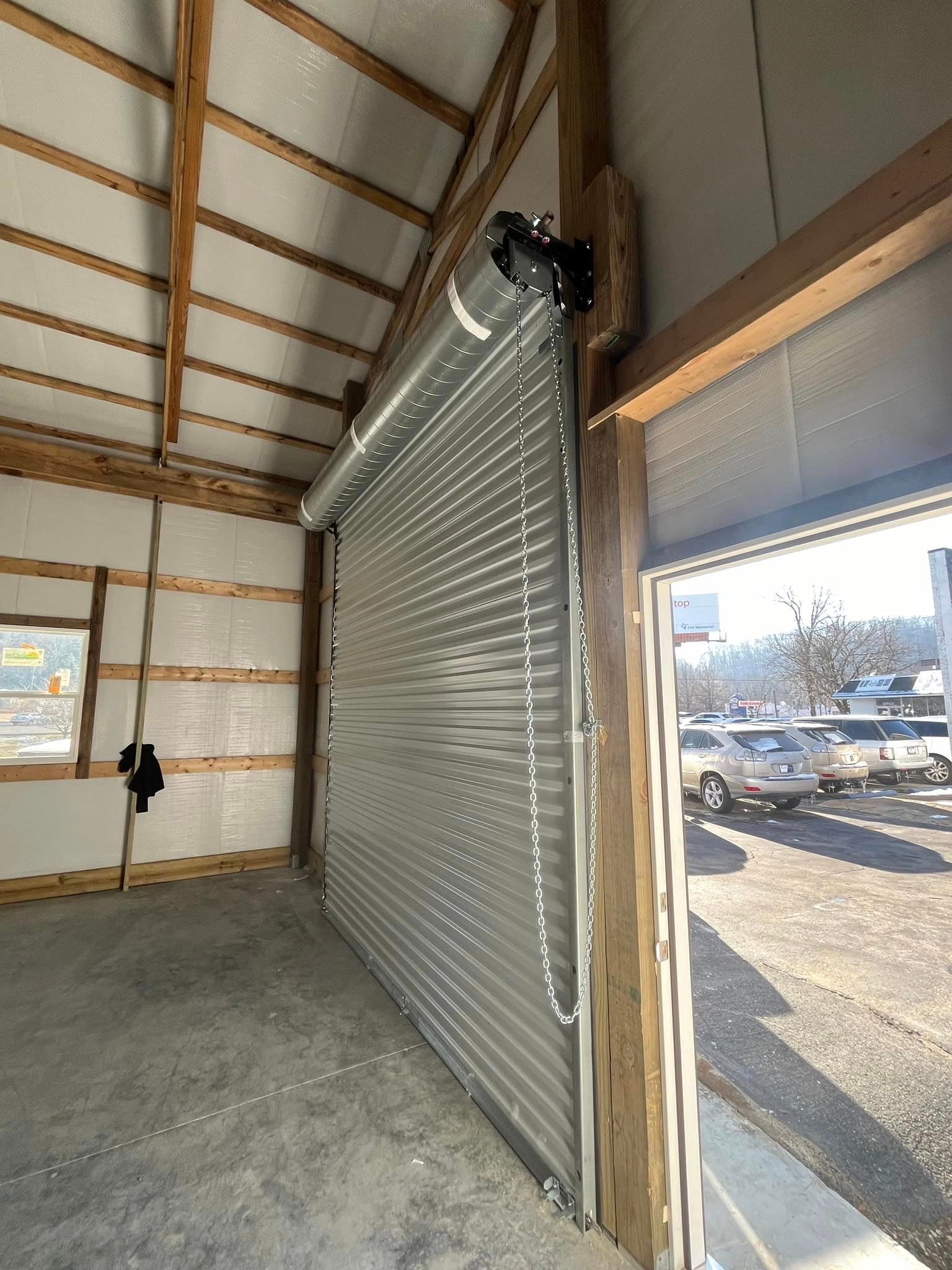 A garage with a roll up door and a window.