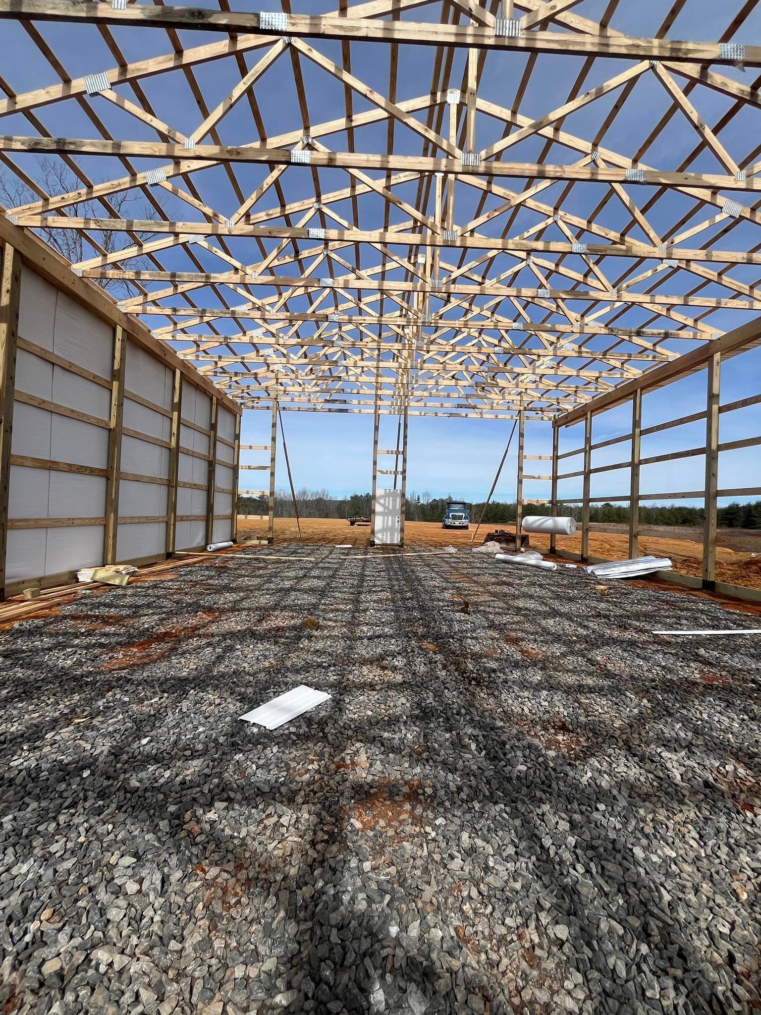 The inside of a building under construction with a lot of wooden beams.
