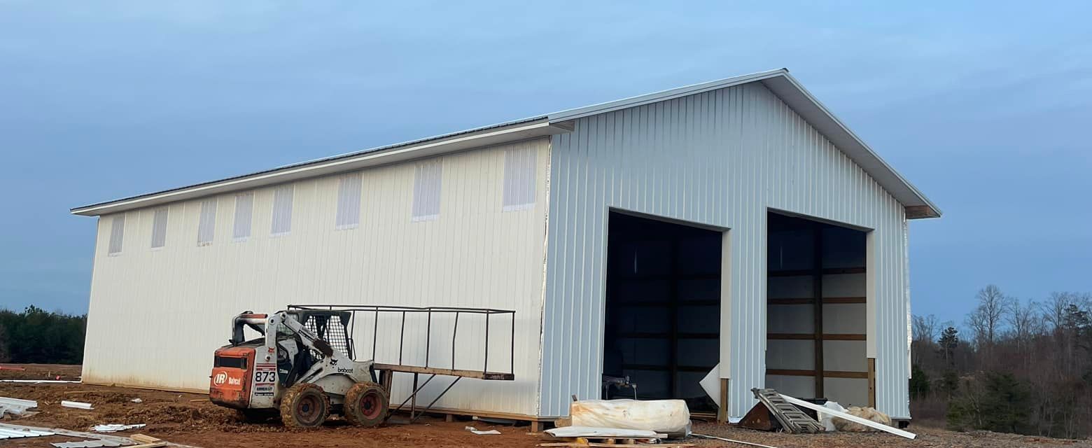 A forklift is parked in front of a large white building.