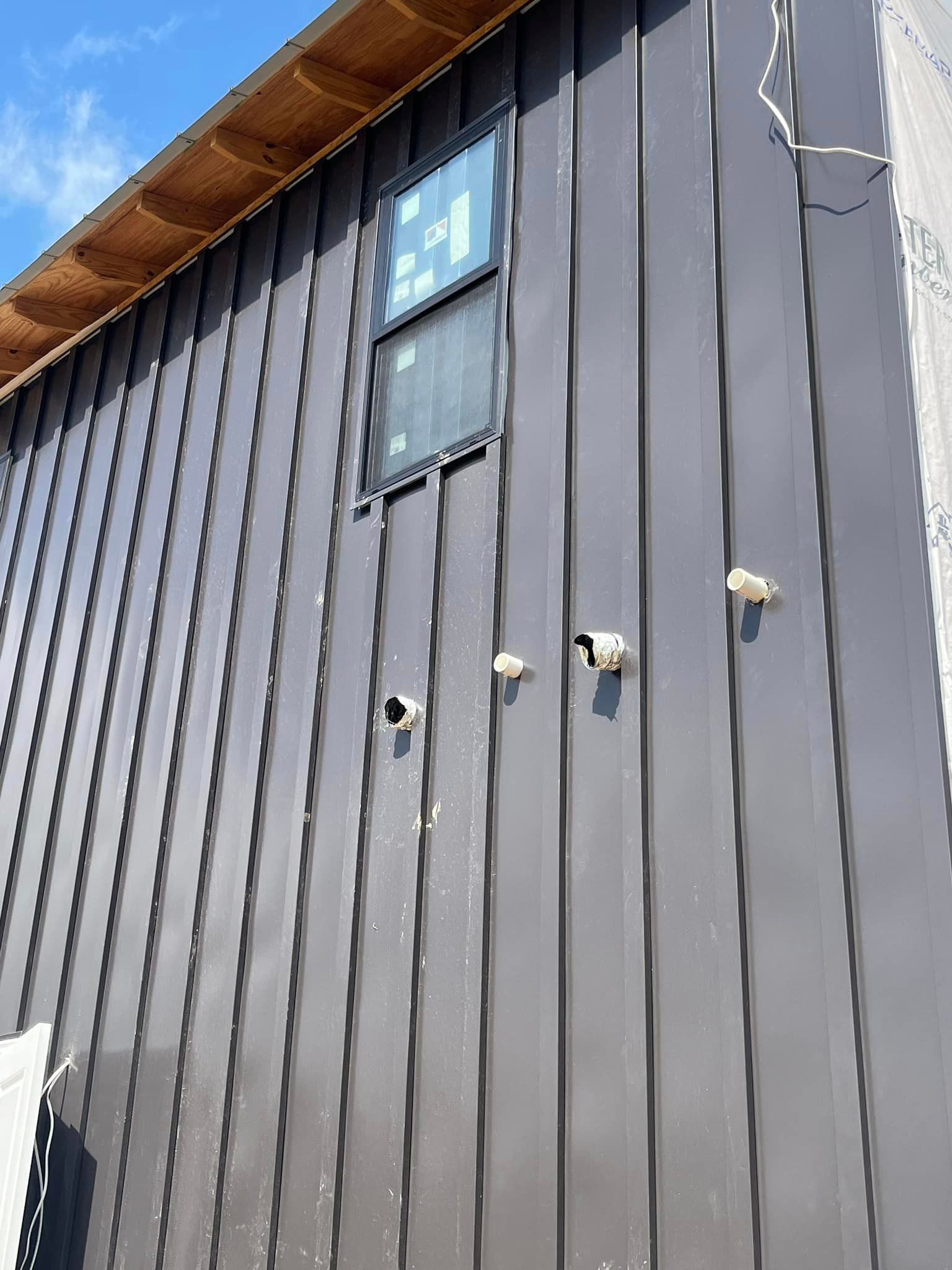 A building with a window on the side of it.