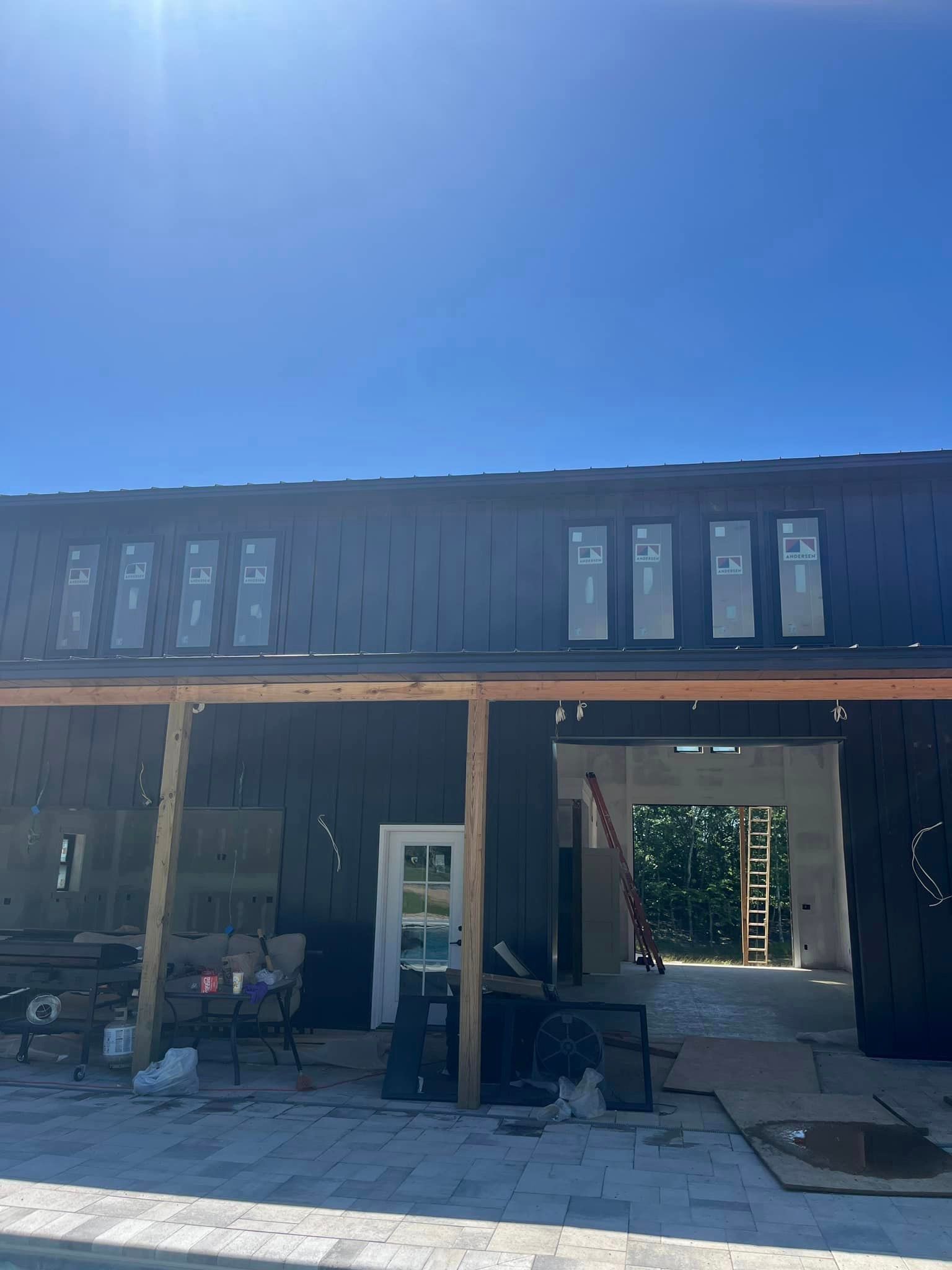 A building under construction with a blue sky in the background.