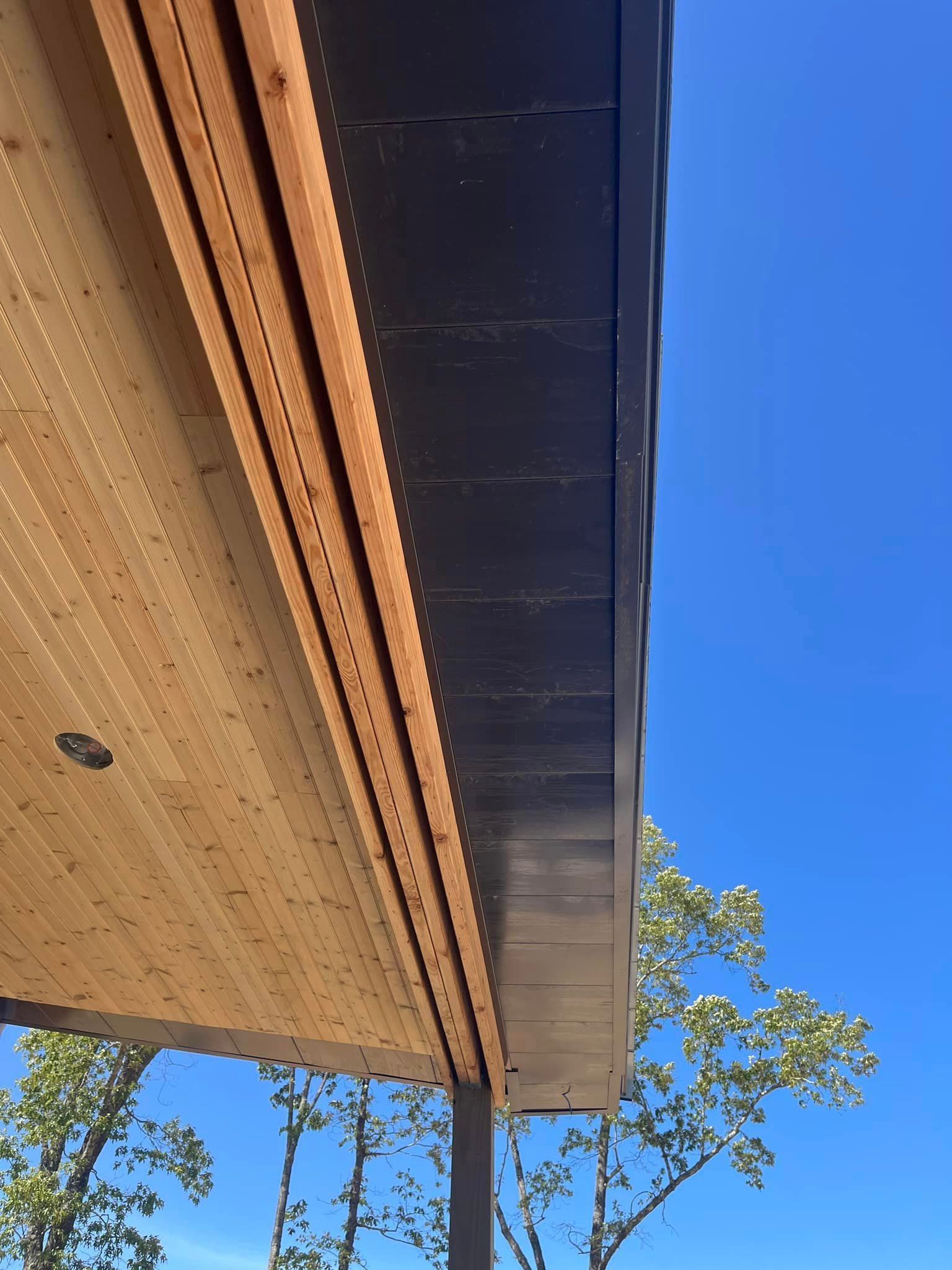 A wooden roof with a blue sky in the background