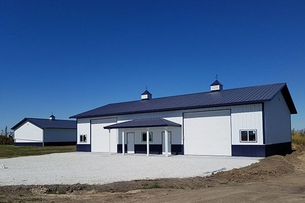 A white building with a blue roof and a porch