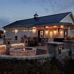 A house with a fire pit in front of it.