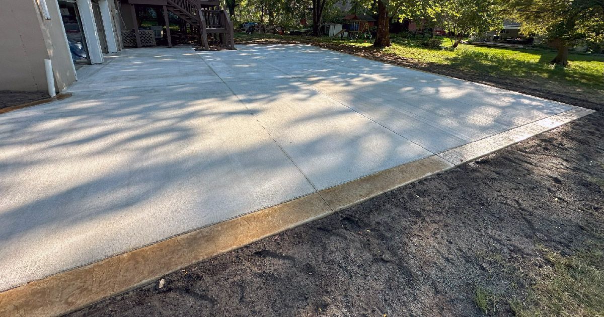 A concrete driveway is being built in front of a house.