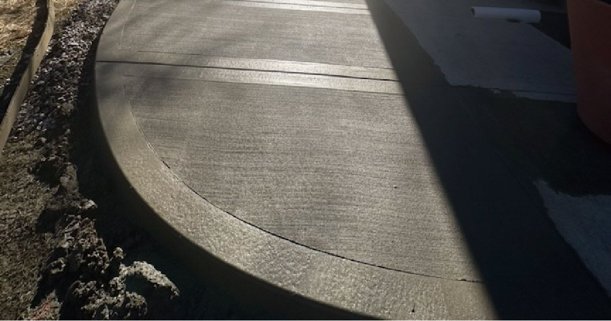 a close up of a concrete curb on a sidewalk .