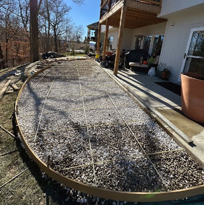 a concrete patio is being built behind a house