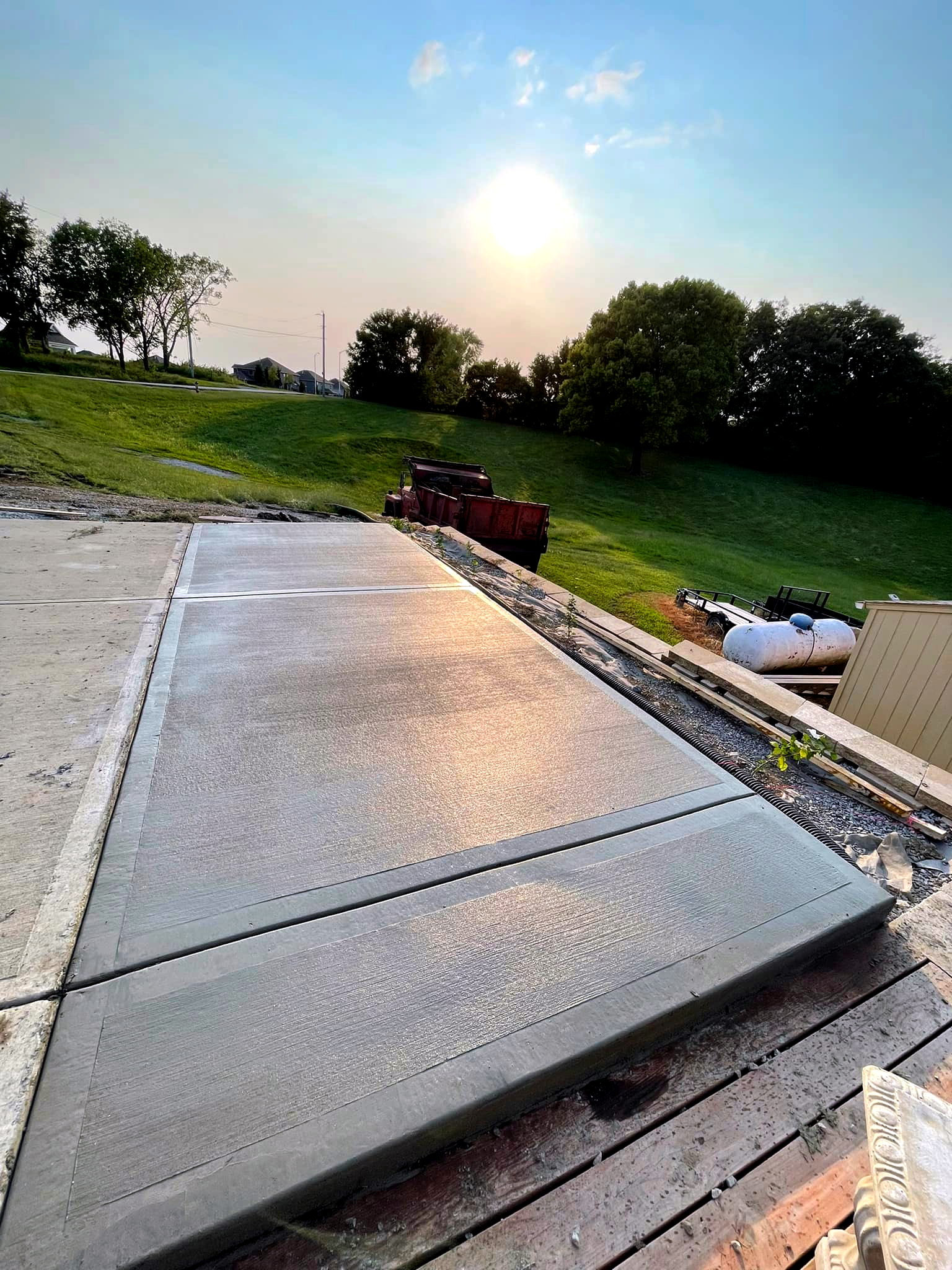 Rural concrete patio by water tank