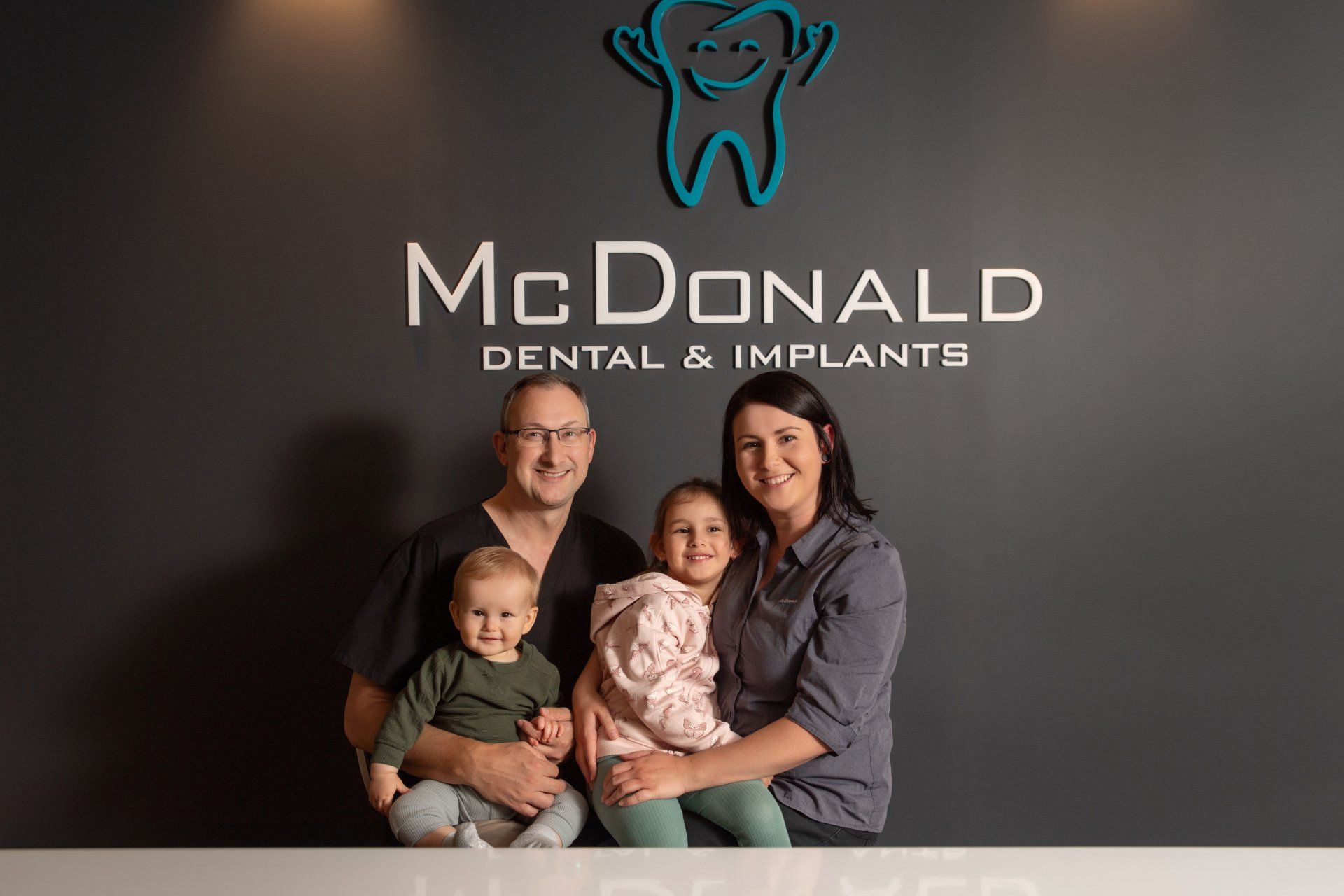 Dentist Carrying A Toddler  — Dental Services in Gympie, QLD