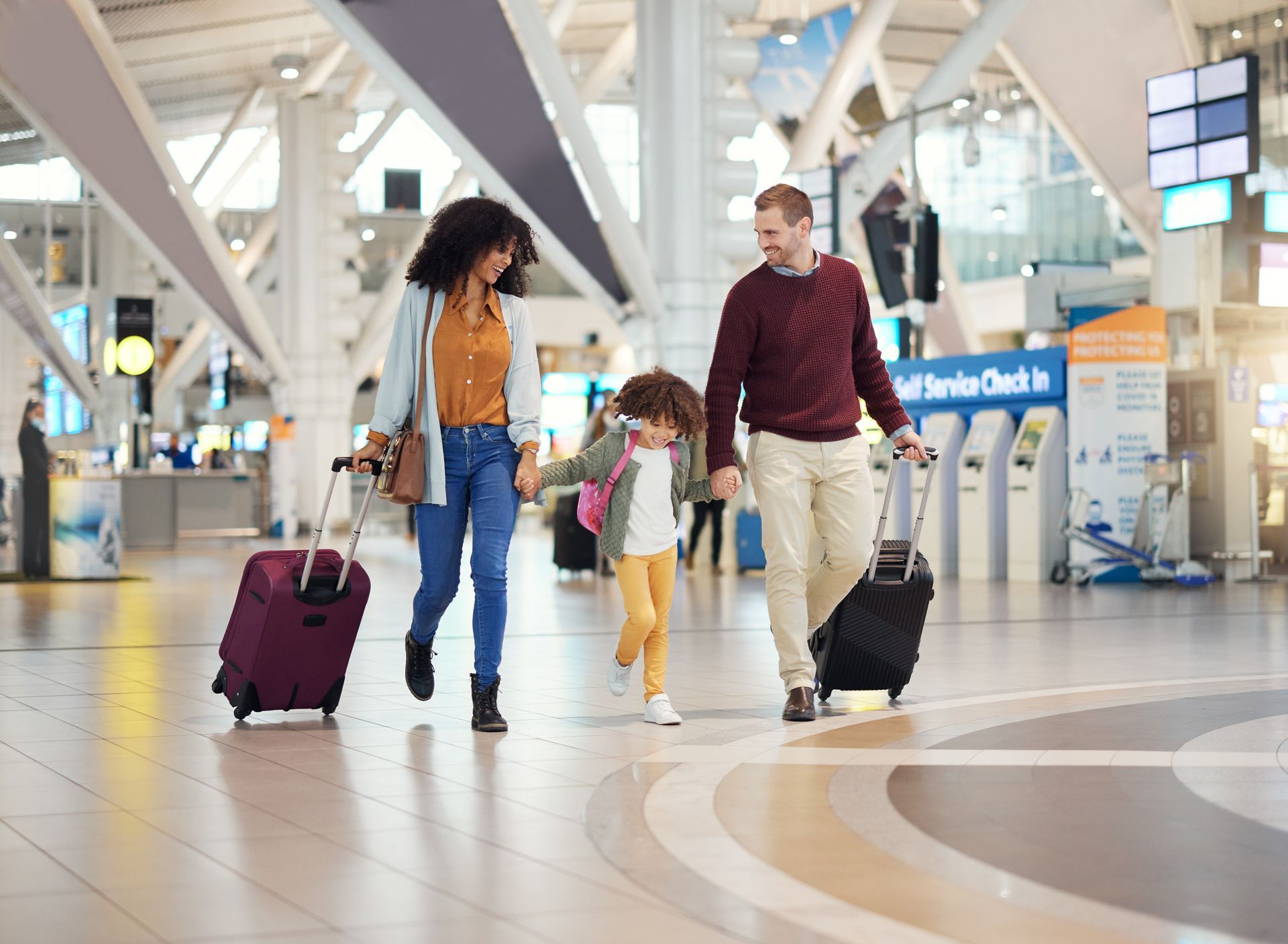 Two people loading a piano onto a moving truck using a dolly.