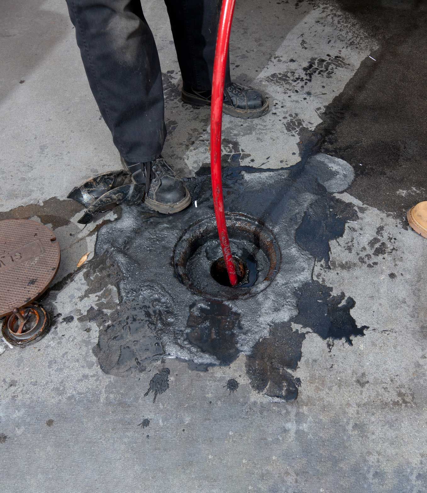 Plumbers are hydro jetting a pipe.