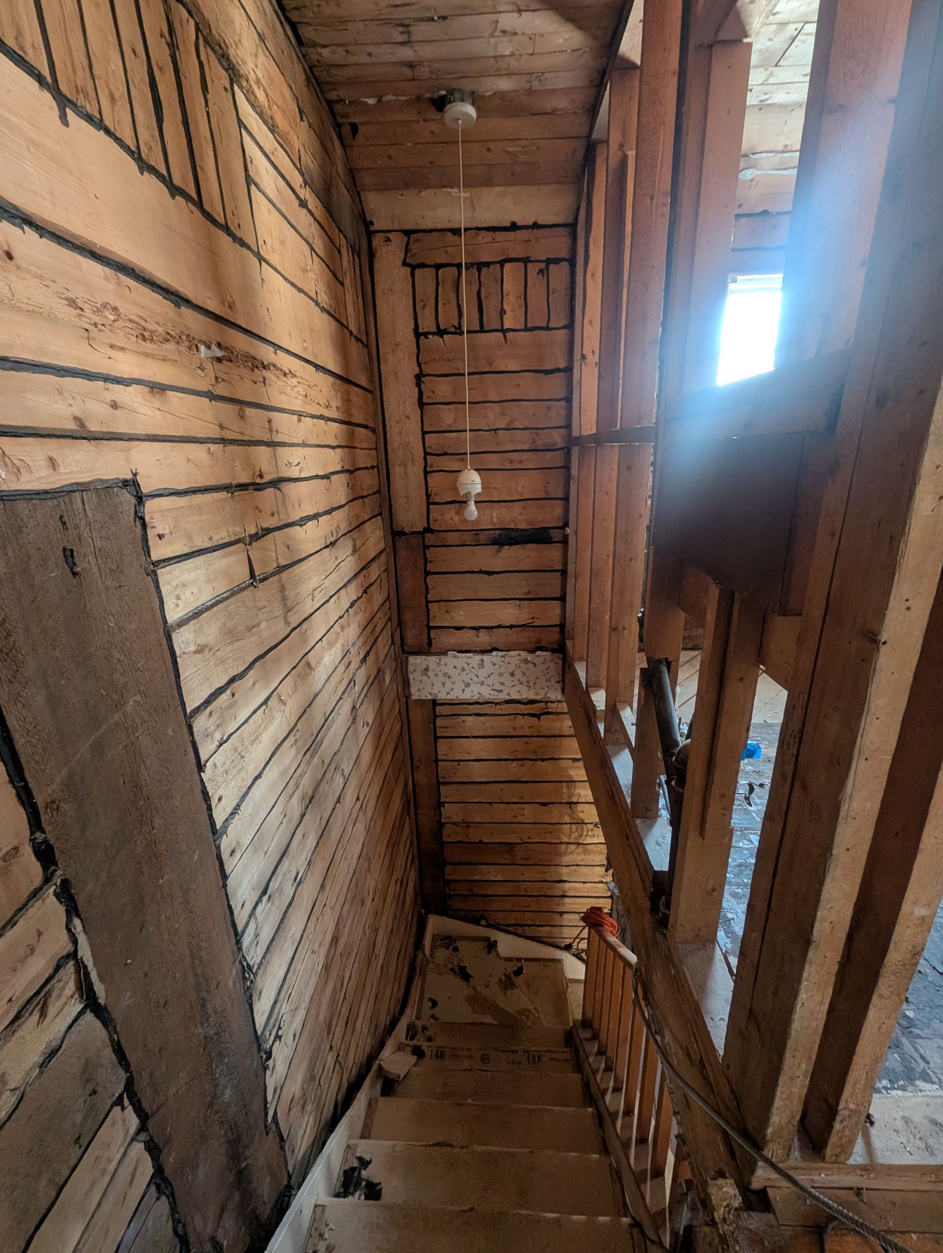 Un escalier en bois menant au deuxième étage d'un immeuble.